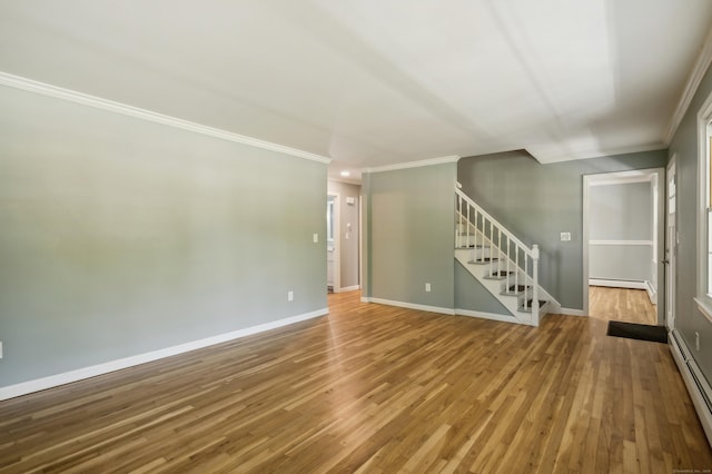 57 Quailcrest Rd, East Lyme, CT 06333 - empty room with crown molding, stairs, a baseboard radiator, wood finished floors, and a baseboard heating unit