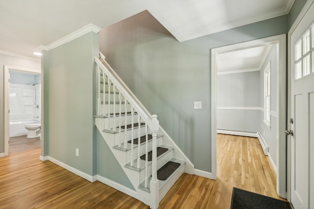 57 Quailcrest Rd, East Lyme, CT 06333 - staircase with crown molding, wood finished floors, baseboards, and a baseboard radiator