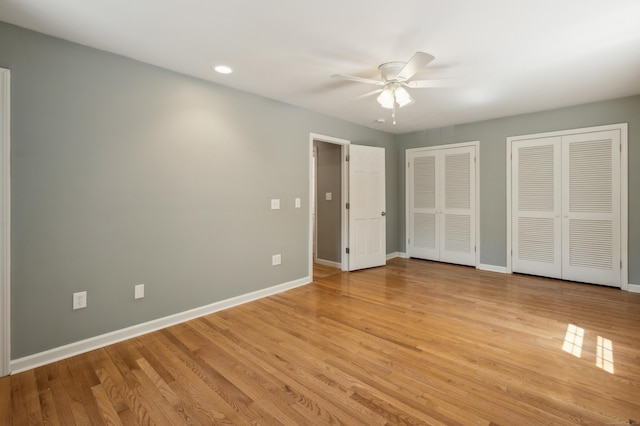 57 Quailcrest Rd, East Lyme, CT 06333 - unfurnished bedroom with two closets, baseboards, light wood-style flooring, and recessed lighting