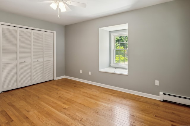 57 Quailcrest Rd, East Lyme, CT 06333 - unfurnished bedroom featuring light wood-style floors, baseboards, a baseboard heating unit, a closet, and a ceiling fan