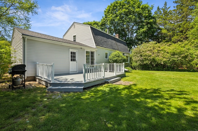 57 Quailcrest Rd, East Lyme, CT 06333 - rear view of house featuring a yard, a deck, a chimney, and a gambrel roof
