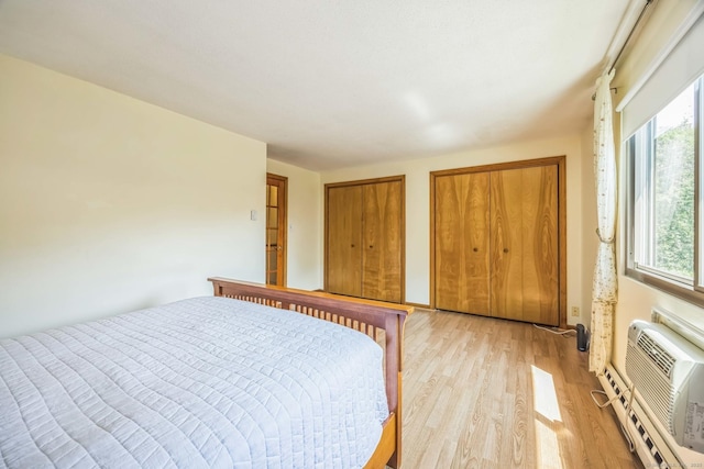 757 Lake Ave Apt 3, Bristol, CT 06010 - bedroom featuring light wood-style floors, multiple closets, and an AC wall unit