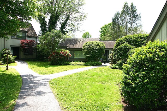 575A Village St, Southbury, CT 06488 - view of front facade with a front lawn, roof with shingles, and board and batten siding