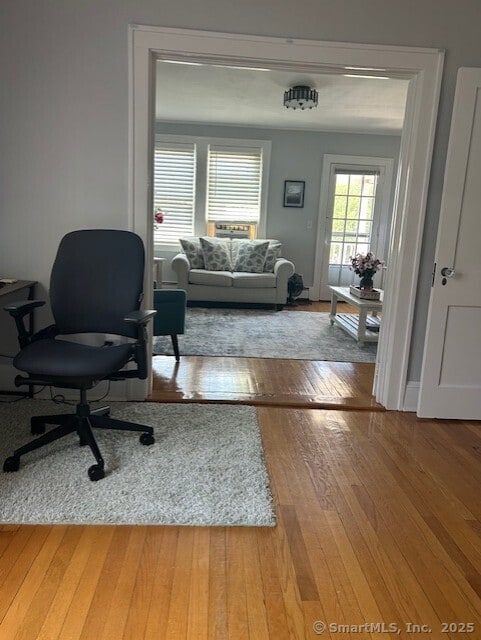 living area with hardwood / wood-style floors and an office area