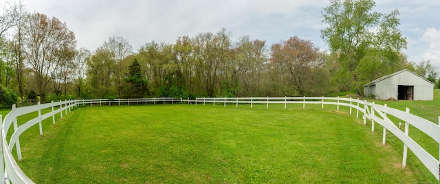view of yard featuring an outdoor structure and a pole building