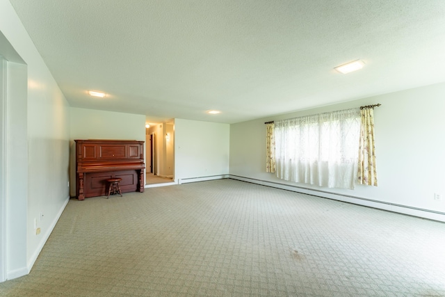 unfurnished living room featuring carpet flooring, baseboards, a textured ceiling, baseboard heating, and a baseboard heating unit