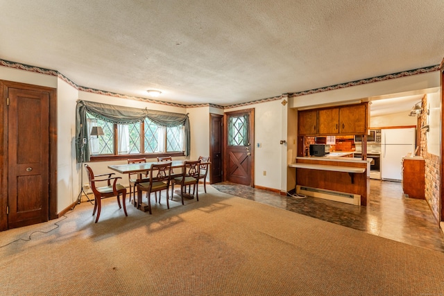 dining space featuring baseboard heating, a textured ceiling, and baseboards