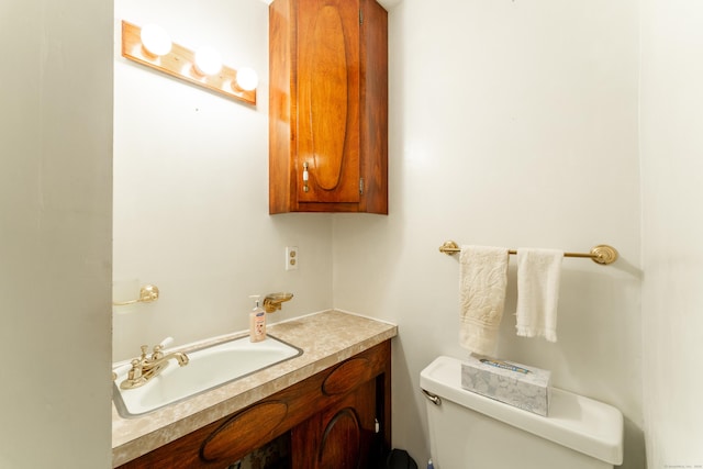 half bathroom with toilet and vanity