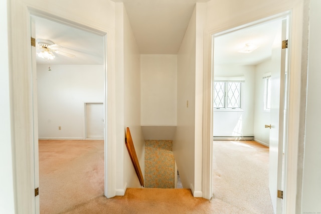 hall featuring carpet floors, a baseboard radiator, and baseboards