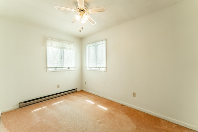 carpeted spare room featuring baseboard heating, ceiling fan, and baseboards