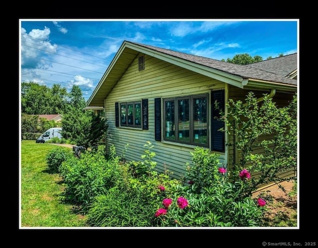 75 Round Hill Rd, New Britain, CT 06052 - view of side of home with a lawn and roof with shingles