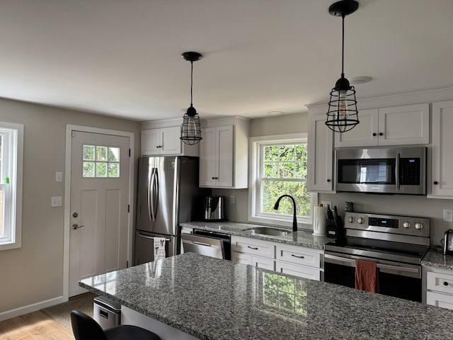 14 Russell St, Hamden, CT 06517 - kitchen featuring stainless steel appliances, plenty of natural light, and white cabinetry