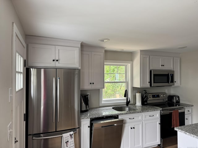 14 Russell St, Hamden, CT 06517 - kitchen with stainless steel appliances, light stone countertops, and white cabinets