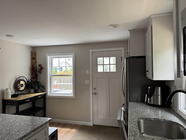 14 Russell St, Hamden, CT 06517 - kitchen with plenty of natural light, light wood-type flooring, and light stone counters