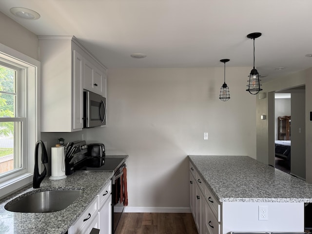14 Russell St, Hamden, CT 06517 - kitchen with stainless steel microwave, black electric range oven, a peninsula, dark wood-style flooring, and white cabinetry
