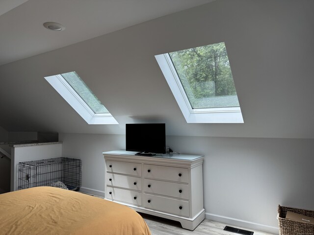 14 Russell St, Hamden, CT 06517 - bedroom with a skylight, lofted ceiling, and light wood-type flooring