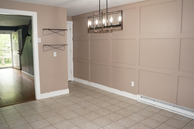 3 Fielding Dr, Montville, CT 06382 - unfurnished dining area with a decorative wall, a chandelier, a baseboard radiator, and baseboards