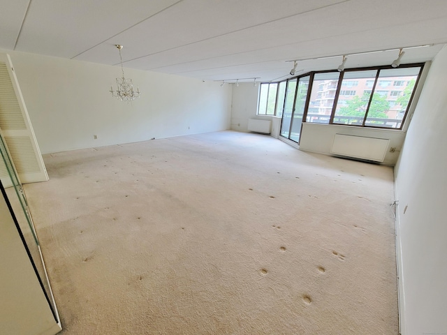 143 Hoyt St Apt 1F, Stamford, CT 06905 - spare room with light colored carpet and a chandelier