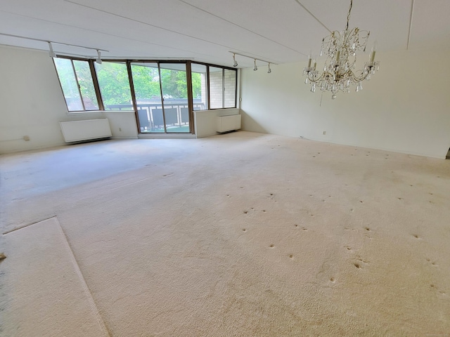 143 Hoyt St Apt 1F, Stamford, CT 06905 - empty room with a chandelier and carpet floors