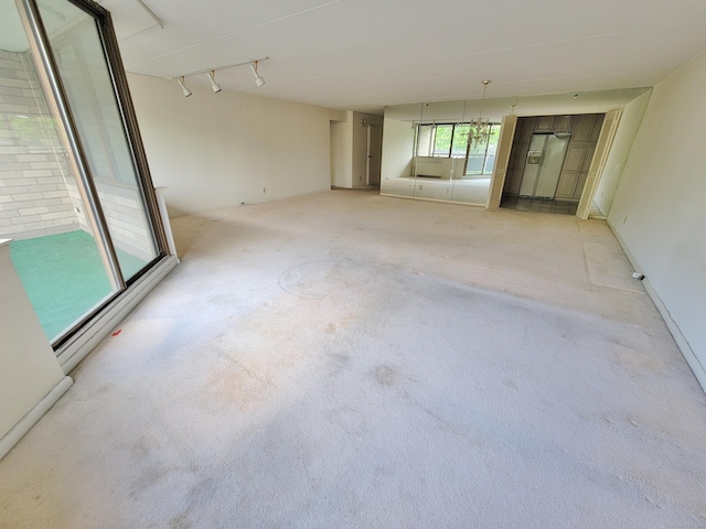 143 Hoyt St Apt 1F, Stamford, CT 06905 - empty room with light carpet and rail lighting