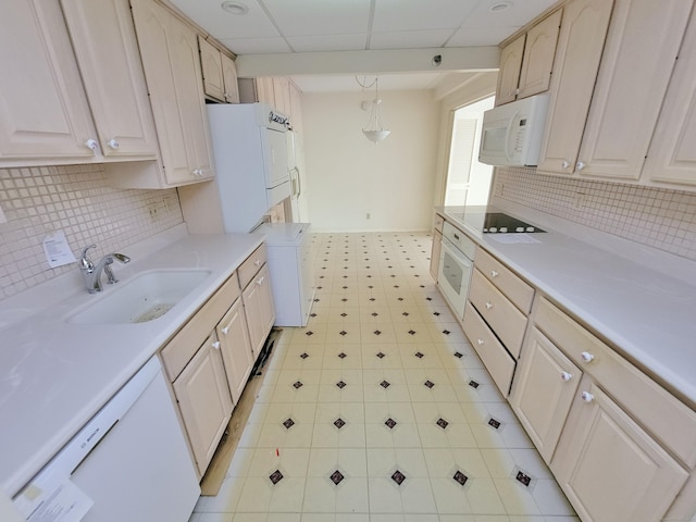 143 Hoyt St Apt 1F, Stamford, CT 06905 - kitchen featuring a sink, white appliances, light countertops, backsplash, and a paneled ceiling