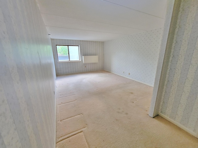 143 Hoyt St Apt 1F, Stamford, CT 06905 - spare room featuring wallpapered walls and carpet flooring