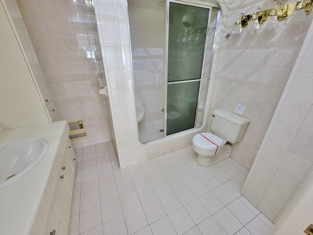 143 Hoyt St Apt 1F, Stamford, CT 06905 - full bath with tile patterned flooring, tile walls, toilet, a shower stall, and vanity