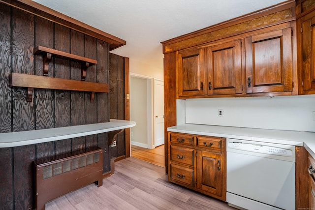 kitchen with dishwasher, light countertops, light wood-style floors, brown cabinets, and open shelves