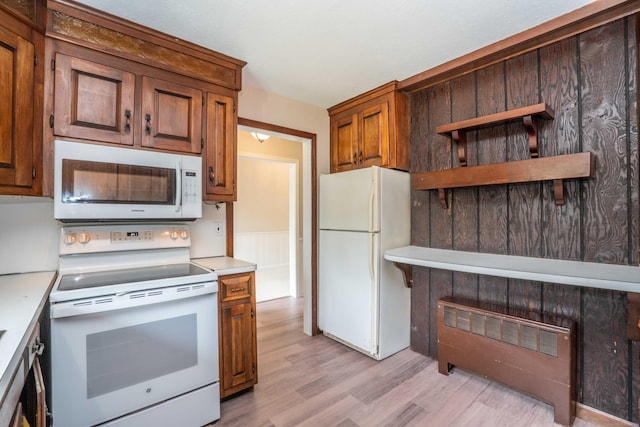 kitchen featuring white appliances, light wood-style floors, light countertops, brown cabinetry, and open shelves