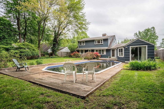 rear view of property with a wooden deck and a chimney
