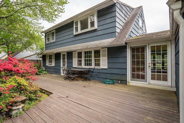 wooden deck with outdoor dining space and french doors