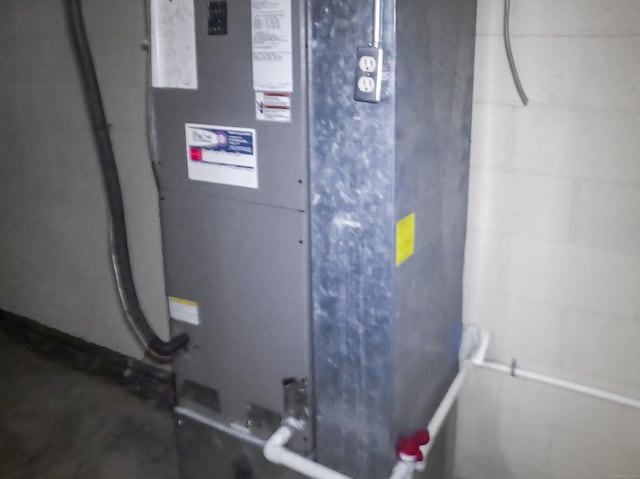utility room featuring heating unit