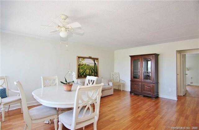 60 Strawberry Hill Ave Unit 1118, Stamford, CT 06902 - dining area featuring a ceiling fan, light wood-style floors, a textured ceiling, and baseboards