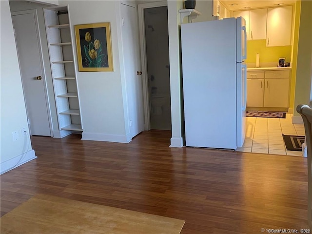 60 Strawberry Hill Ave Unit 1118, Stamford, CT 06902 - kitchen featuring freestanding refrigerator, wood finished floors, light countertops, baseboards, and built in features