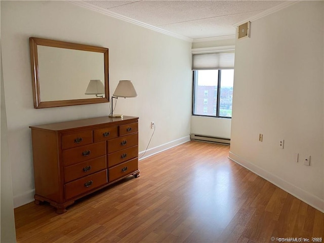 60 Strawberry Hill Ave Unit 1118, Stamford, CT 06902 - empty room featuring baseboard heating, light wood finished floors, crown molding, baseboards, and a textured ceiling