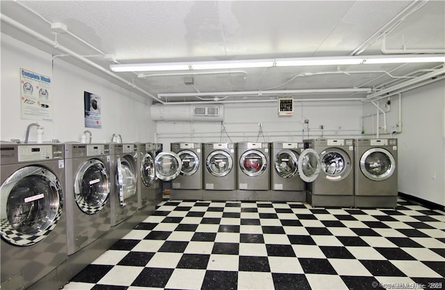 60 Strawberry Hill Ave Unit 1118, Stamford, CT 06902 - communal laundry room featuring washing machine and clothes dryer, tile patterned floors, and a garage
