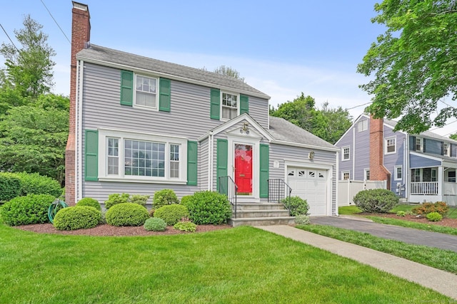 67 Matthew Dr, Stratford, CT 06614 - view of front of home with asphalt driveway, a chimney, an attached garage, and roof with shingles