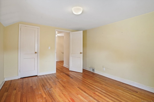 67 Matthew Dr, Stratford, CT 06614 - unfurnished bedroom featuring light wood finished floors, baseboards, and vaulted ceiling