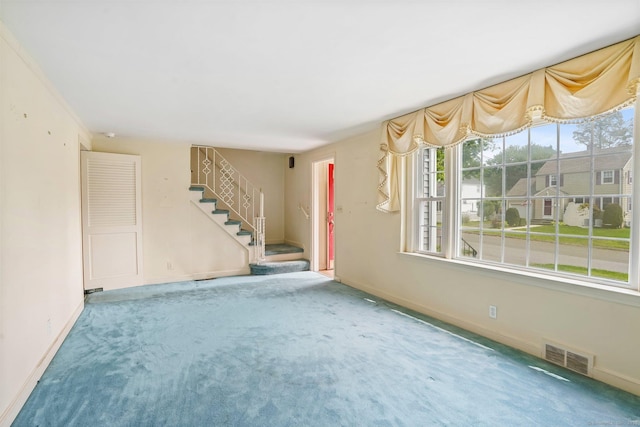 67 Matthew Dr, Stratford, CT 06614 - unfurnished living room featuring carpet floors, stairway, and baseboards