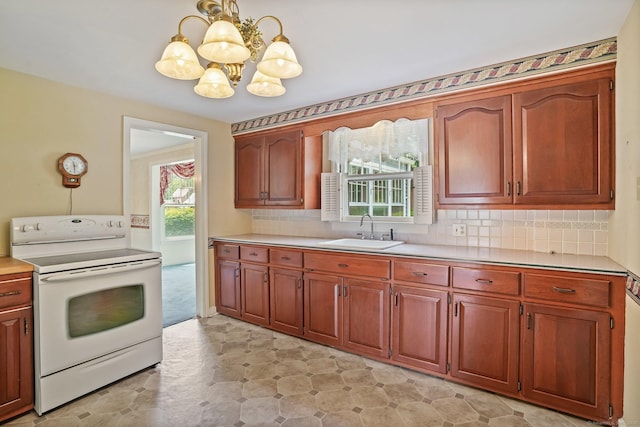 67 Matthew Dr, Stratford, CT 06614 - kitchen featuring electric range, a sink, a chandelier, light countertops, and backsplash