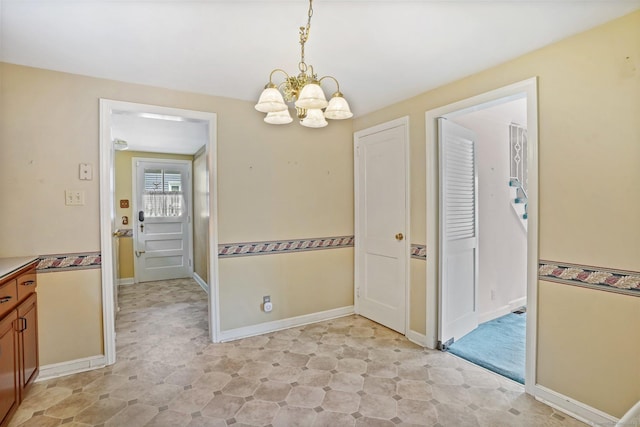 67 Matthew Dr, Stratford, CT 06614 - unfurnished dining area featuring a chandelier and baseboards