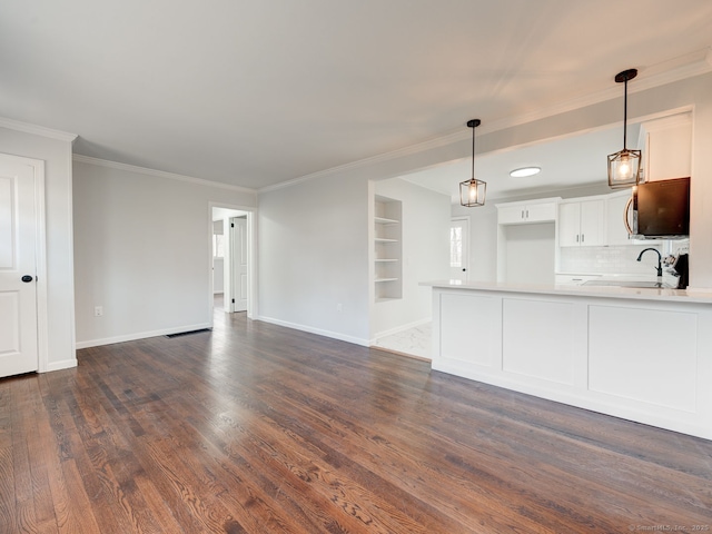 37 Austin Rd, Durham, CT 06422 - unfurnished living room featuring baseboards, dark wood-style floors, crown molding, and built in features