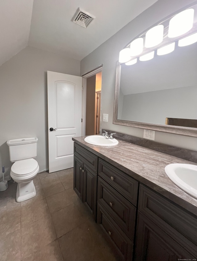 41 Secret Lake Rd, Canton, CT 06019 - bathroom with toilet, double vanity, tile patterned floors, and lofted ceiling