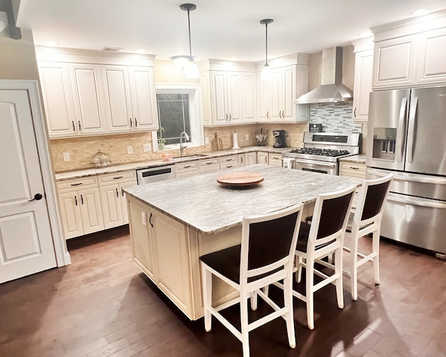 41 Secret Lake Rd, Canton, CT 06019 - kitchen with stainless steel appliances, wall chimney range hood, a sink, a kitchen breakfast bar, and a center island