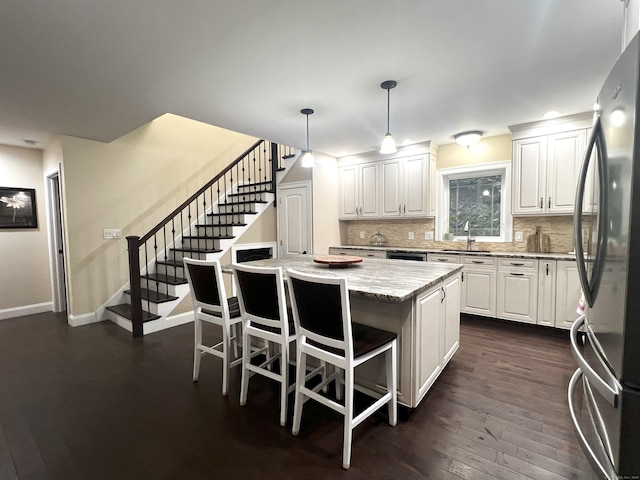 41 Secret Lake Rd, Canton, CT 06019 - kitchen featuring freestanding refrigerator, a sink, white cabinets, decorative backsplash, and a kitchen island