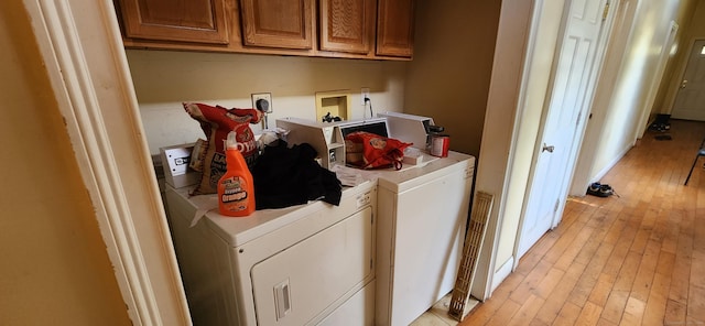 75 Clifton St, West Haven, CT 06516 - washroom featuring separate washer and dryer, light wood finished floors, and cabinet space