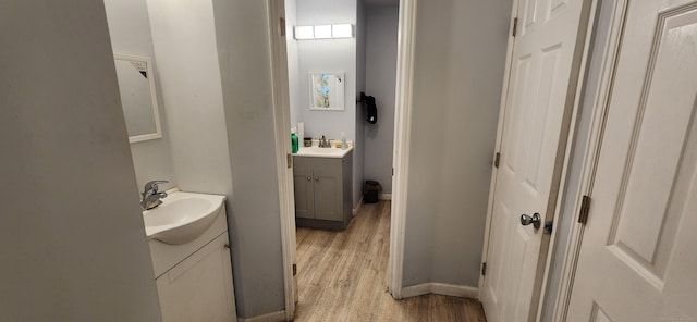 75 Clifton St, West Haven, CT 06516 - bathroom with two vanities, wood finished floors, and baseboards