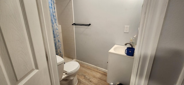 75 Clifton St, West Haven, CT 06516 - bathroom with toilet, wood finished floors, tiled shower, vanity, and baseboards