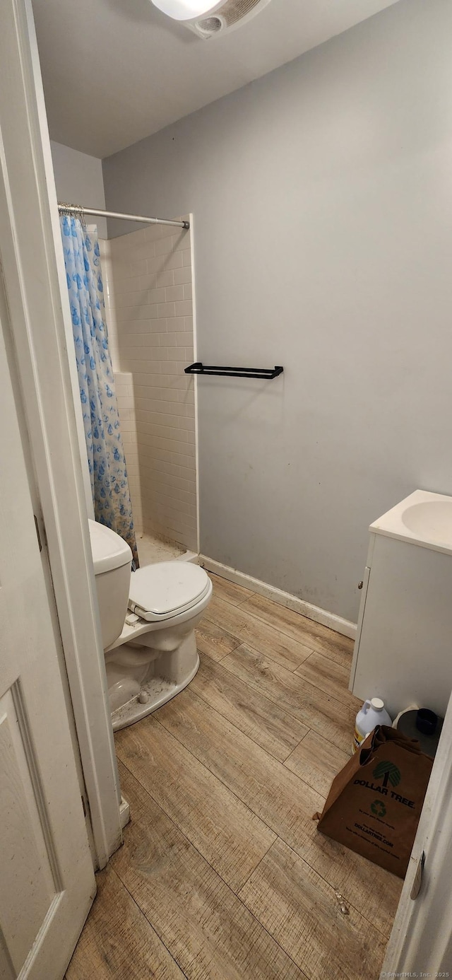 75 Clifton St, West Haven, CT 06516 - full bathroom with toilet, wood finished floors, a shower with shower curtain, and vanity
