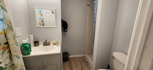 75 Clifton St, West Haven, CT 06516 - full bathroom featuring wood finished floors, a shower stall, vanity, toilet, and baseboards